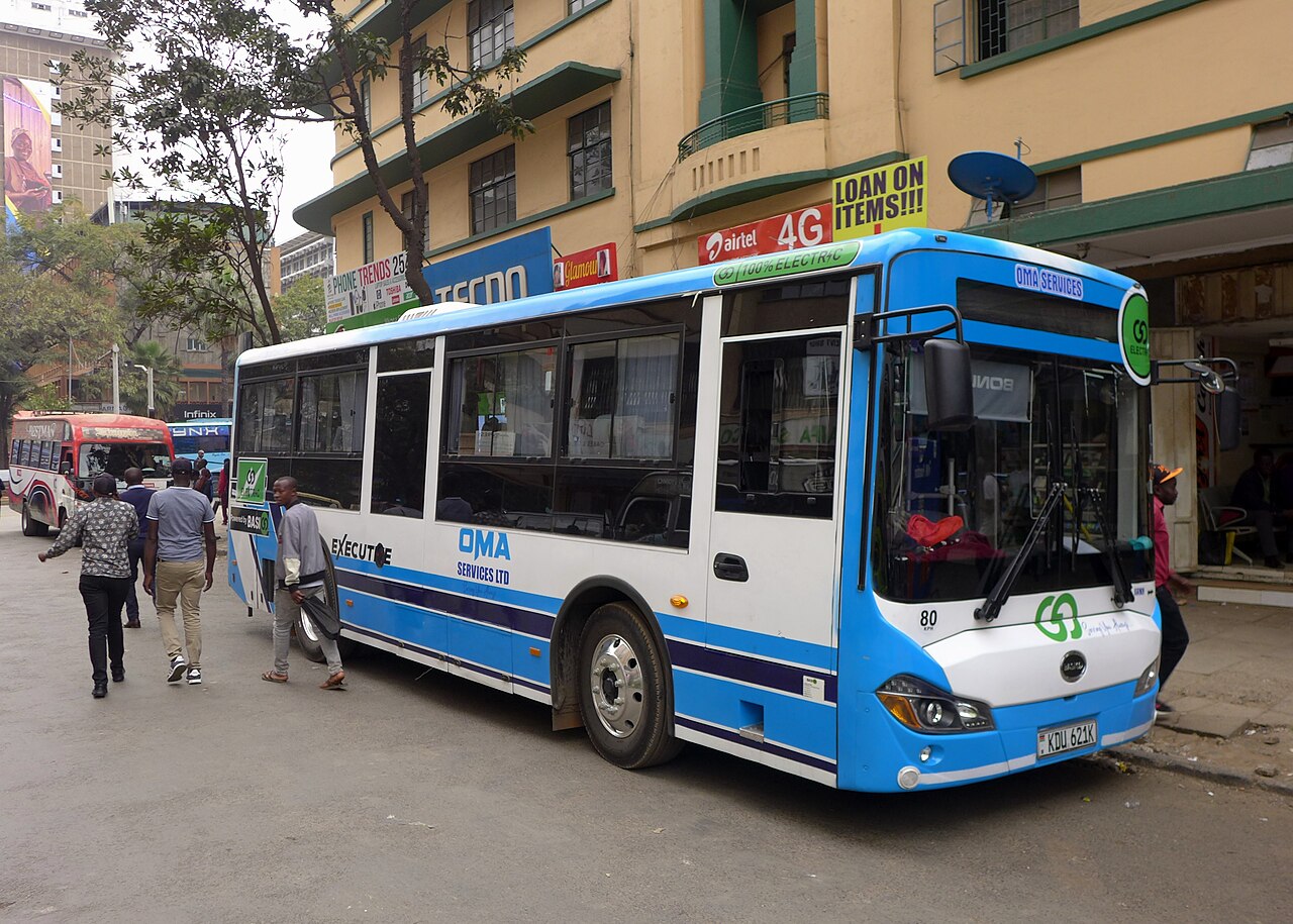An OMA Services BasiGo E9 Kubwa electric bus on Gedi Street, Nairobi, 2025.